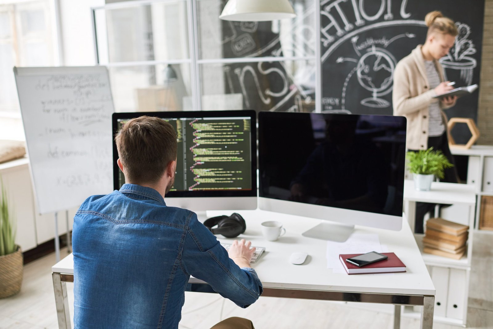 Developer at a desk with code editor and a St. Charles County